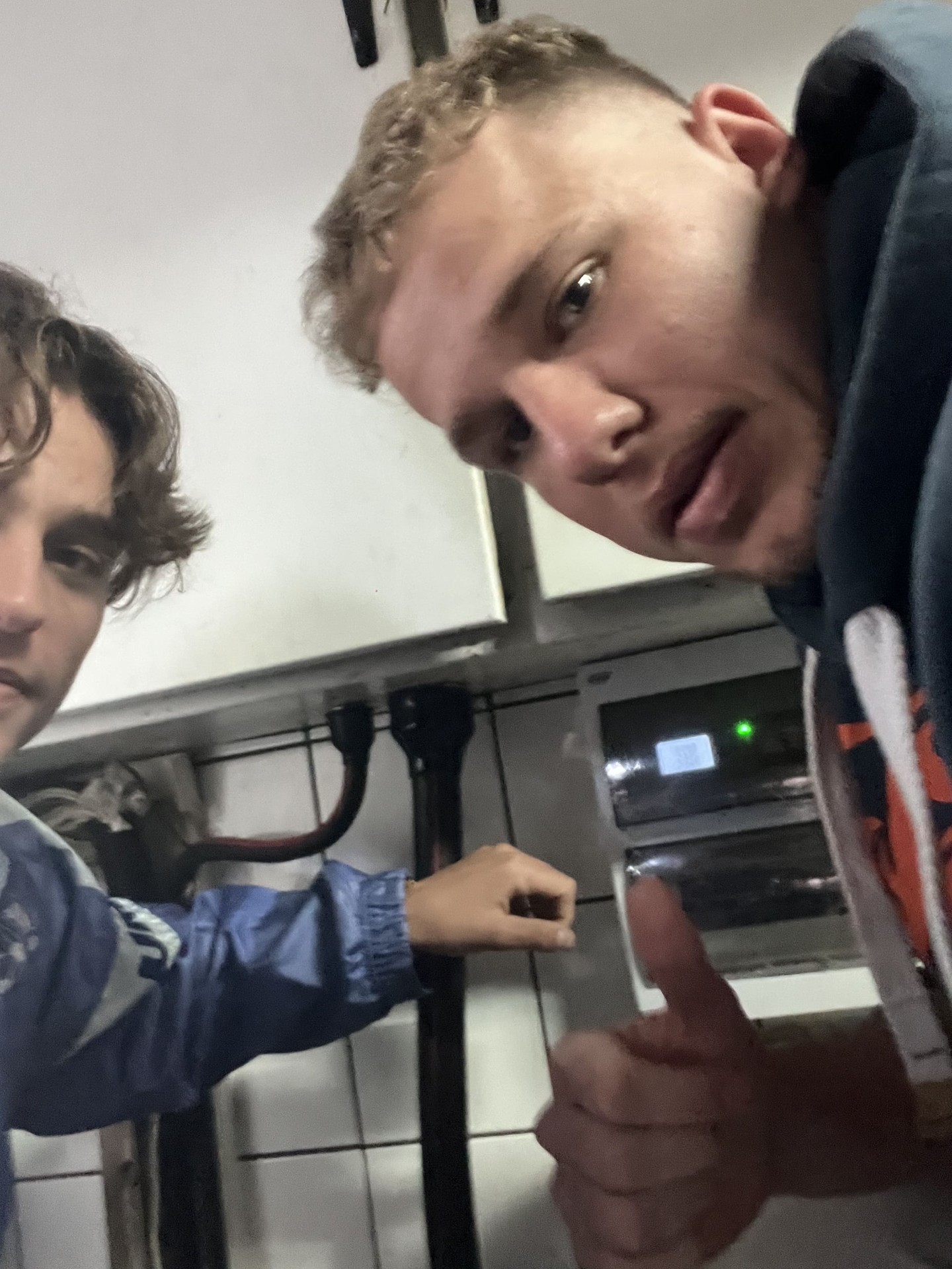 Matteo Buxman and a colleague at an electrical distribution panel during a metering installation